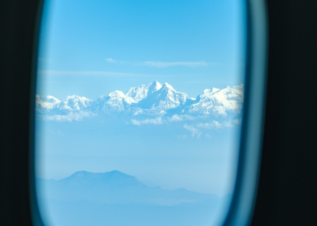 View of snow peaked Himalayas from the plane window 