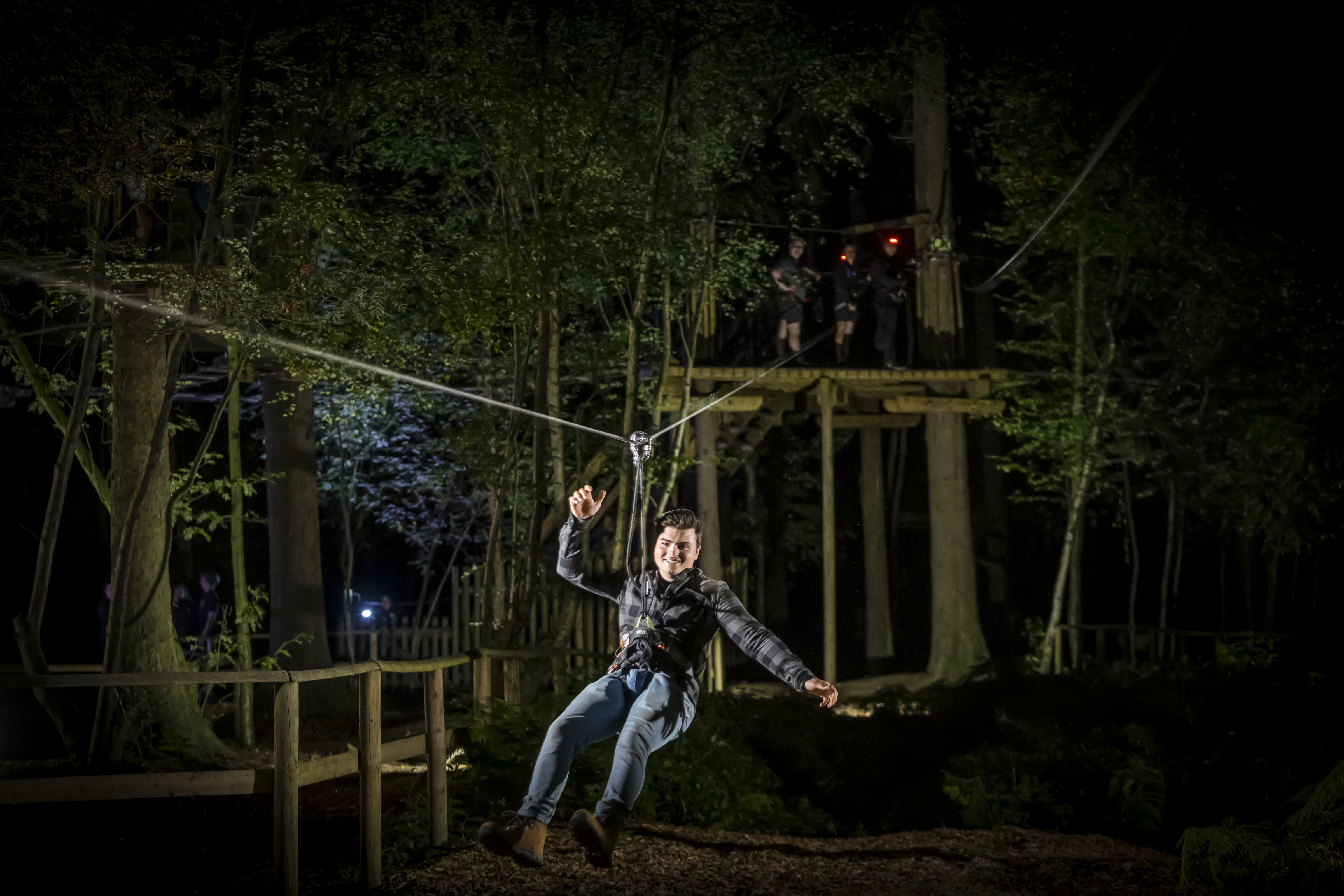 Man on Go Ape Sundown Session on zip line