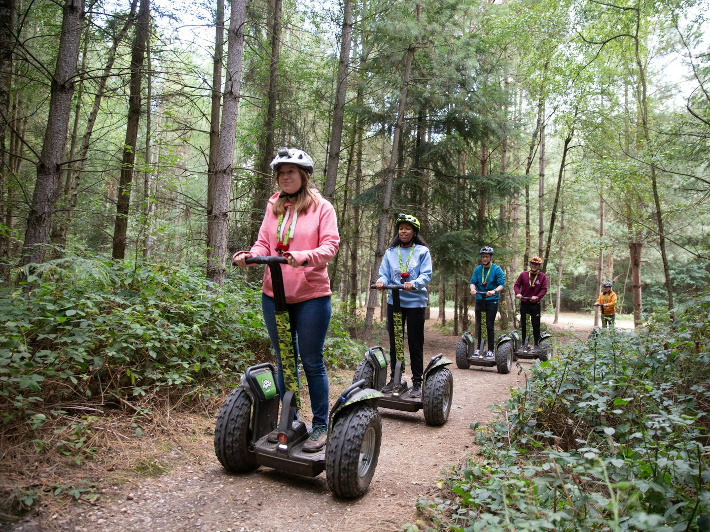 A group of people ride Forest Segways on a Go Ape adventure