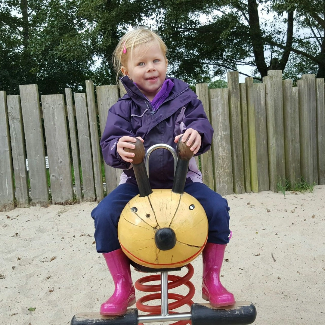 A young girl in an children's play area