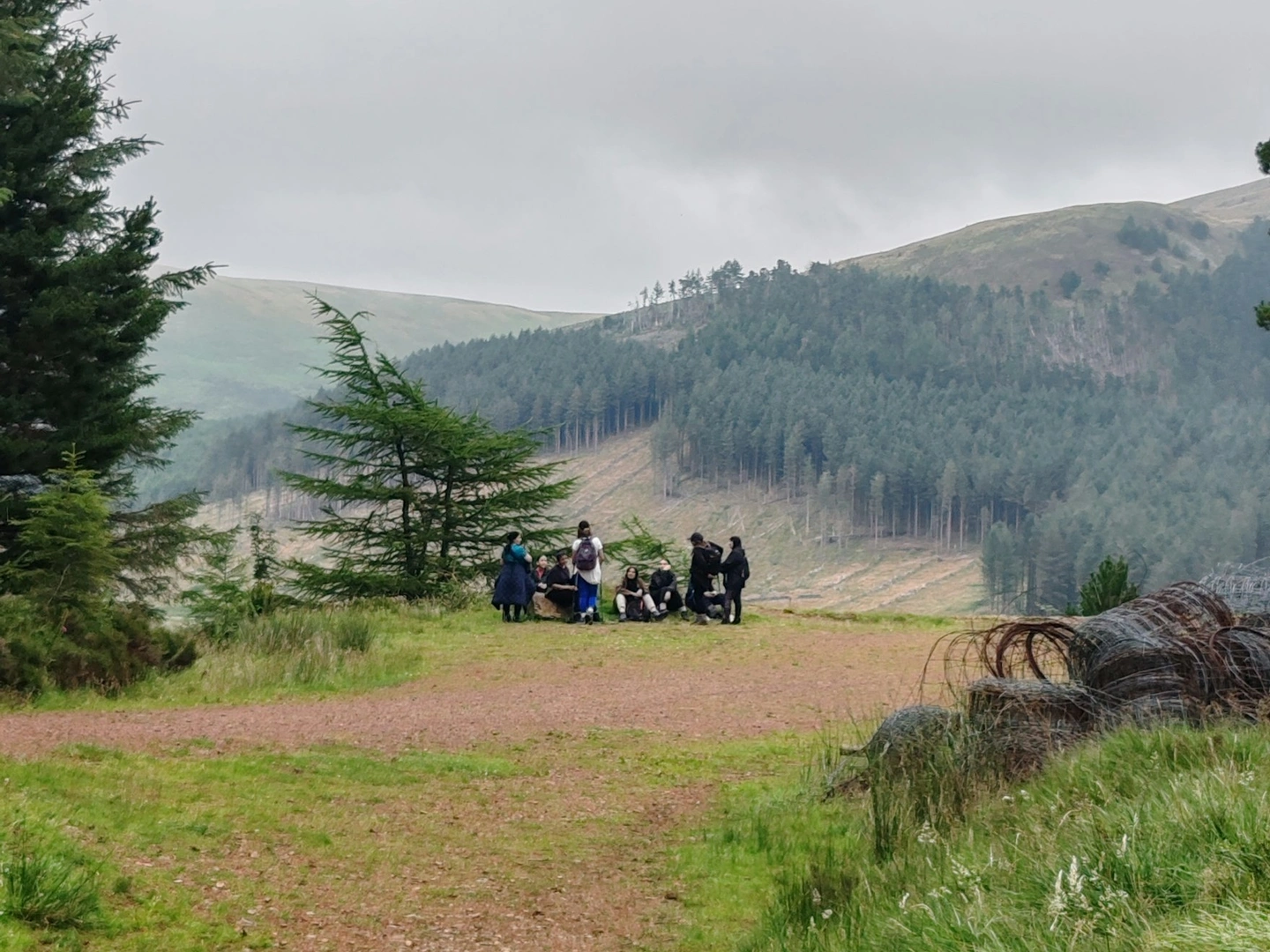 Walking group in the distance around beautiful hills.