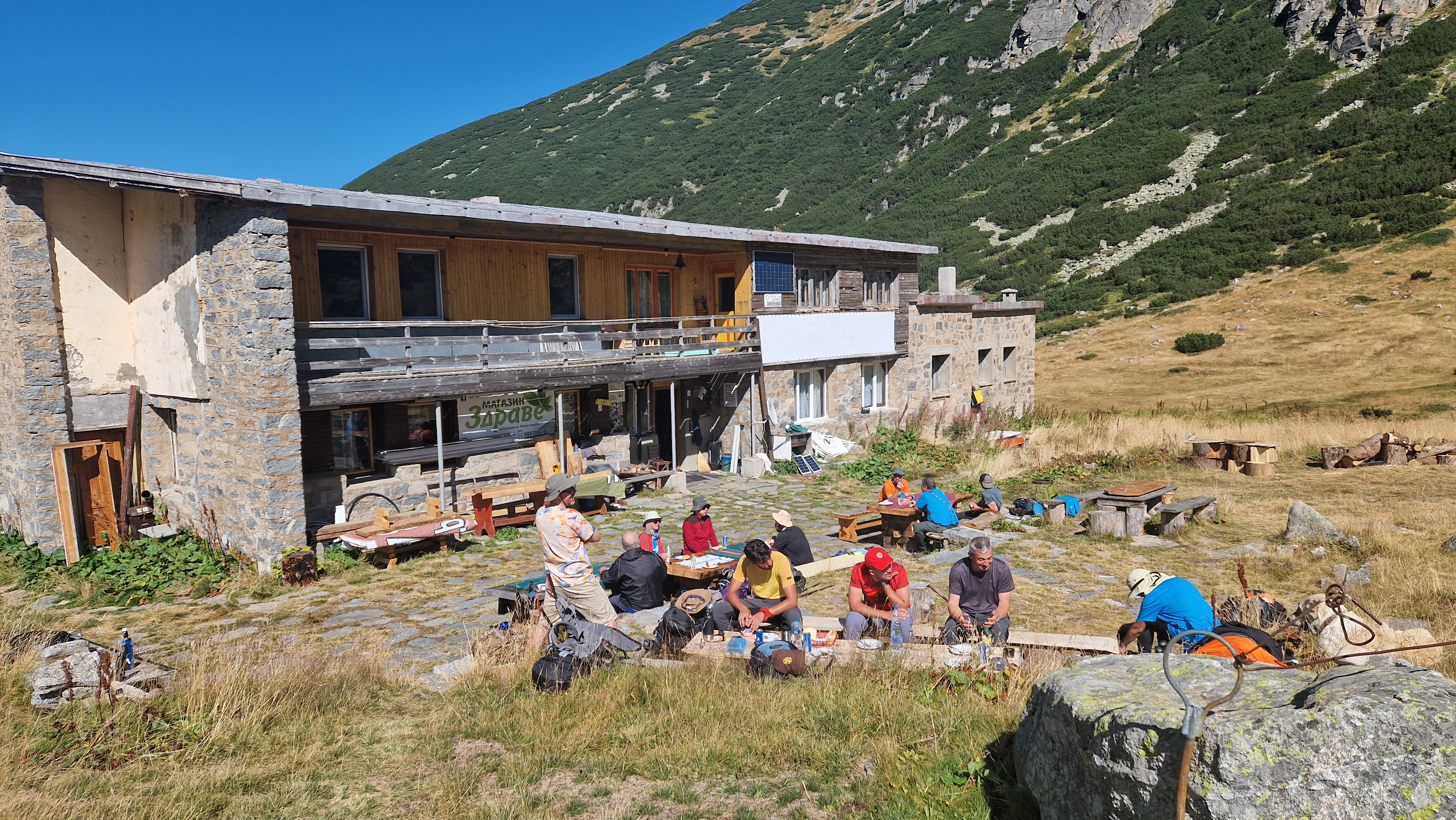 The TEN Trek Musala team gathered by a mountain hut for lunch on their trek in the Rila Mountains