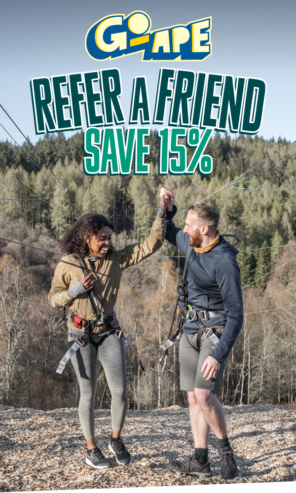 A couple celebrating on a Go Ape zip wire landing site with the text Refer a Freind Save 15%