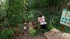 A woman stepping of a Go Ape Plummet