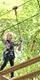 Young girl on Treetop Adventure crossing at Go Ape