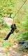 Young girl in black on Go Ape Treetop Adventure Pluz zip line