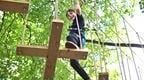 Boy in blue on Go Ape Treetop Adventure crossing