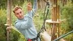 man in grey top on Go Ape crossing  | how to plan a stag do