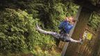 expressive woman on Go Ape zip line 