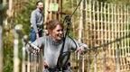 Woman in grey jumper on Go Ape treetop challenge experience
