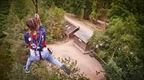 woman in blue and red on Go ape zip line with cabin underneath  | How to plan a hen do