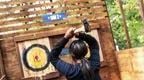 Young Woman in blue Go Ape Axe Throwing 