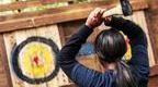 Young Woman in blue Go Ape Axe Throwing 