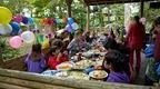 A group of children enjoying a birthday party in the forest shetler at Go Ape Forest of Dean