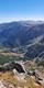 A view of blue sky mountain peaks and a valley with a lake in the Rila Mountains Bulgaria