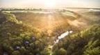 View of scenic landscape filled with Forest Holiday cabins 