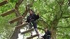 Two girls in black on Treetop Challenge experience 