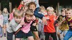 children holding up certificates by Go Ape cabin