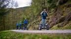 A group of adults riding Forest Segways at Go Ape Whinlatter Forest