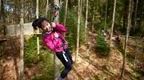 Woman in pink on Treetop Challenge Crossing