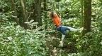 Woman in orange top swining from the trees!