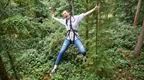woman smiling and posing on Go Ape zip line  | How to plan a hen do