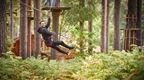 man in black hoodie on Go Ape zip line in forest  | how to plan a stag do
