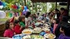 a Go Ape Forest Shelter packed full of people at a kids birthday party