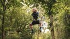 A child on a Go Ape zip wire part of a day trip for boarding schools