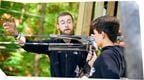 A go ape instructor talking to a young male customer on Go Ape Treetop Adventure