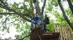 A man in blue on the Plummet at Go Ape Alexandra Palace