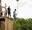 woman dressed in black jumping from plummet platform.