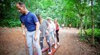 A group of colleagues enjoying ground based games on their Go Ape outdoor team day