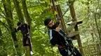 Two men on Go Ape crossing for a fun stag do