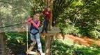 A girl and a boy on a Go Ape crossing