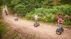 A group of colleagues riding Forest Segways on their Go Ape outdoor team day