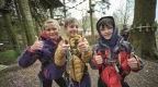 a group of children in a cold weather outfits and Go Ape harnesses ready for a Go Ape adventure in cold weather