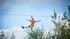 A man enjoying a Go Ape zip wire ride on his outdoor team day near Exeter