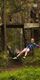 A boy wearing a colourful top yells as he enjoys a thrilling zip wire ride on a Go Ape adventure