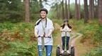 A woman and her colleagues riding Go Ape Forest Segways for a fun team day near Birmingham