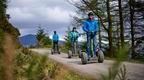 A group of people riding Forest Segways along a trail as part of their experience day gifts