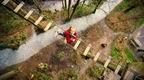 Girl in red on Go Ape Treetop Adventure crossing