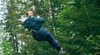 woman in blue coat going down zip 