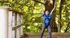 Child celebrating at the bottom of a Go Ape zip wire