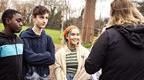 Teenagers talking to Go Ape instructor.