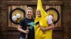 woman in blue top and woman in banana costume holding axes in front of target  | How to plan a hen do