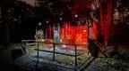 A Go Ape Axe Throwing arena lit at night, ready for a coporate team building day or work Christmas party