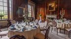 A formal dining room with a stunning fireplace, perfect for conferences at Coombe Abbey hotel in the Midlands